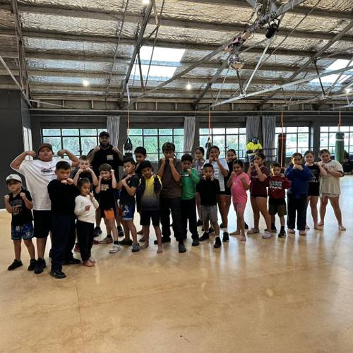 The kids boxing class lined up with their guards up